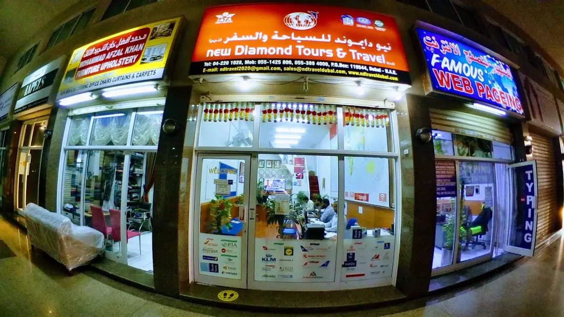 New Diamond Tours and Travel storefront lit up at night